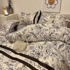 a bed with black and white flowers on it