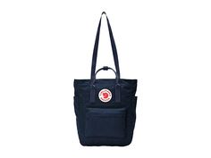 Fjallraven Kanken Totepack - Tote Handbags : Navy : The Fjällräven Kånken Totepack is functional and versatile enough to take anywhere, transforming from a tote, to a backpack with ease when changing commute options or walking around the supermarket. Waterproof G-1000 HeavyDuty Eco S fabrication keeps your stuff dry all-day long. Main compartment can hold all your daily essentials. Interior lined with a padded base for tablets. Zippered top main compartment opening. Front zippered compartment fo Fjallraven Kanken Totepack, Kanken Totepack, Fjällräven Kånken, Zipper Top, Daily Essentials, Fjallraven Kanken, Fjallraven Kanken Backpack, Product Reviews, Tote Handbags