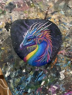 a rock with a colorful dragon painted on it