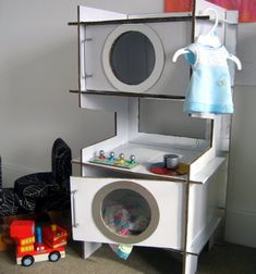 a doll house made out of an old washing machine