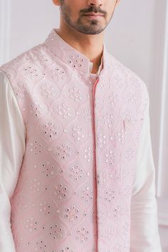 Powder pink Nehru jacket in pure georgette base fabric featuring machine and mirror embroidered motifs.
Component: 1
Pattern: Embroidered
Type Of Work: Mirror Work
Neckline: Mandarin
Sleeve Type: Sleeveless
Fabric: Pure Georgette; Lining: Twill Satin
Color: Pink
Other Details: 
Front button down jacket
Pocketed jacket
Note: The kurta and churidar worn by the model is not for sale
Occasion: Wedding - Aza Fashions Designer Pink Nehru Jacket With Zari Work, Pink Nehru Jacket With Zari Work For Spring, Spring Pink Nehru Jacket With Zari Work, Festive Pink Nehru Jacket With Resham Embroidery, Spring Wedding Pink Nehru Jacket, Pink Nehru Jacket With Zari Work For Festive Occasions, Pink Nehru Jacket With Resham Embroidery For Reception, Pink Long Sleeve Bandhgala With Cutdana, Festive Pink Nehru Jacket With Intricate Embroidery