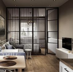 a living room filled with furniture and a flat screen tv on top of a wooden table