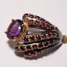 Faceted Rhodolite / Rubellite Garnet And Amethyst Ring. Stamped 925. Black Rhodium Plated With 14k Gold Overlay Accents For Contrast And For Highlighting The Stones. Artistic Very Unique Ring. Asymmetrical Ring, Gold Overlay, Rhodolite Garnet, Unique Ring, Black Rhodium, Women Artisans, 925 Jewelry, Amethyst Ring, Womens Jewelry Rings