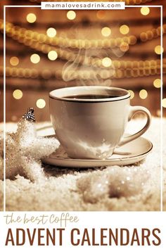 a cup of coffee sitting on top of a saucer next to a christmas tree