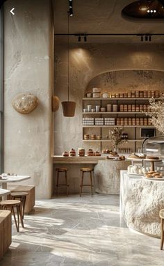 the inside of a store with tables and stools