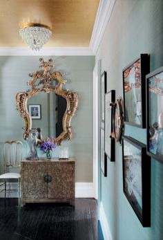 the hallway is decorated with antique furniture and mirrors