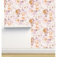 a white wall with pink and orange flowers on it