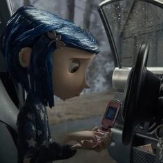 a cartoon character is holding a cell phone in the driver's seat of a car