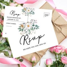 wedding rsp card with flowers on it next to envelopes and pink ribbon tied around them