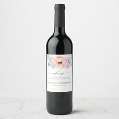 a bottle of wine with a floral label on it