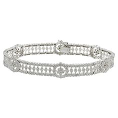 Experience the epitome of luxury with this stunning estate 18KT white gold fancy flower filigree diamond bracelet. Featuring 2.90CT-TW of G-I VS SI round brilliant cut diamonds, this exclusive piece exudes timeless elegance and impeccable craftsmanship. This bracelet is the perfect accessory to elevate any outfit and is a true testament to the quality and beauty of fine jewelry. Don't miss the opportunity to add this exquisite treasure to your collection. 22.43 grams. Retro Bracelet, Stunning Earrings, Brilliant Diamond, Vintage Bracelets, Sparkle Diamonds, Round Brilliant Cut Diamond, Diamond Stone, Round Cut Diamond, Brilliant Cut Diamond