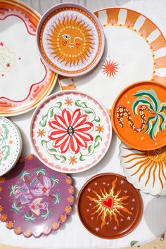 colorful plates with designs on them sitting on a table