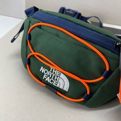 (New+Tag) The North Face Belt Bag / Sling Pack Hiking / Streetwear Festival Friendly Front Zip Cards Slot Inside Zip Compartment Size 10.5” Top X 6.5” Bottom Depth 3” Top Green Navy Multi