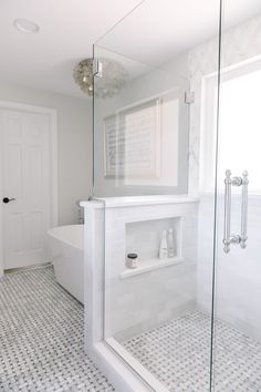 a bath room with a tub a sink and a mirror on the wall in it