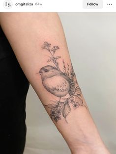 a small bird with flowers on its arm