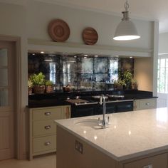 a kitchen with marble counter tops and an island in front of the stove top oven