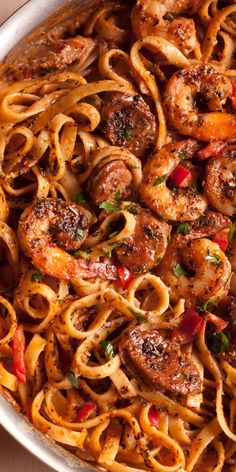 pasta with shrimp and tomato sauce in a pan