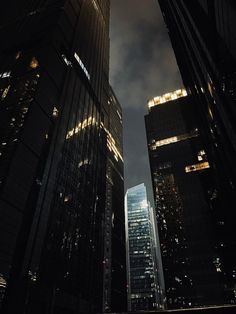 some very tall buildings in the city at night