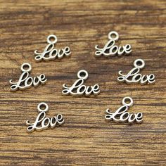 100pcs Love Charms Word Charms Antique Silver Tone 13x10mm CF2924Perfect for jewelry making like earrings, bracelet, necklace as well as zipper pull, bookmark, key chain, handbag charm, wine charm making, gift decoration and much more! ♣ Qty: 100pcs ♣ Size: 13x10mm approx     "Conversion: 1mm=0.0393 inch"♣ Color: Antique Silver♣ Material: Zinc Metal Alloy ( Lead Free, Nickle Free)♣ Package: Opp Bag in Bubble Envelope⑴  We only ship to the confirmed address you left on Etsy.⑵  Please convo us for Doodle Frames, Chain Handbag, Jewellery Making Materials, Charm Making, Handbag Charms, Activity Days, Love Charms, Wine Charms, Mini Heart