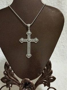 This cross pendant set in silver-toned metal makes a gorgeous necklace. It's very large and detailed. It's a budded style with lots of designs. It's reversible, too. On one side the ends have concave areas. On the reverse they're convex. This cross itself measures 59mm wide by 80mm long. With the bail and jump ring, it is 96mm long. It hangs from a decorative metal bail. It is photographed with a simple ball chain but can be purchased as the pendant only, with the ball chain, or with a nicer cha Ornate Cross Necklace With Intricate Design, Silver Cross Necklace With Large Pendant, Ornate Silver Cross Pendant Necklace, Ornate Silver Cross Necklace, Metal Cross, Cross Chain, Cameo Pendant, Decorative Metal, Cross Pendant Necklace