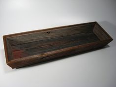 an empty wooden tray on a white surface