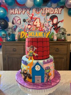 a spiderman themed birthday cake on a table