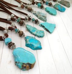 Western Jewelry / Turquoise and Leather Necklace / Southwestern Necklace  Welcome to Sun Sea Studio. These Southwestern Style one of a kind necklaces have  turquoise color irregular pendant stones  accented with turquoise / silver / bronzite  beads. They are wrapped with silver tone wire. The whole pendant measures  between 3 - 3.5 inches from bale to tip. ( See Quarter in photo for size reference) The brown double suede necklace on each is 26 inches long. You can put this right over your head. The knot at the top is tight and glued.  Choose A, B, C, D, E, F, G, H or I. Ready to ship!         All Sun Sea Studio designs are created with an eye for detail, gorgeous color and visual balance. Sun Sea Studio jewelry glistens in the sun and in the evening lights!          If you would like to se Rustic Adjustable Turquoise Beaded Necklaces, Adjustable Rustic Turquoise Beaded Necklace, Rustic Turquoise Adjustable Beaded Necklace, Rustic Turquoise Beaded Necklaces, Adjustable Rustic Turquoise Necklace, Rustic Adjustable Turquoise Necklace, Western Style Blue Necklace For Festival, Adjustable Southwestern Turquoise Necklace For Festivals, Southwestern Adjustable Turquoise Necklace For Festivals