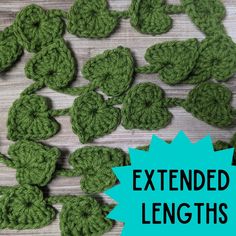 green crocheted shamrocks laid out on a wooden surface with the text extended lengths