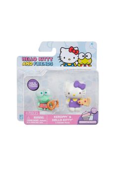 two hello kitty figurines in plastic packaging