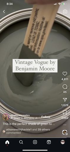 a person is holding a paint can with the words vintage voque by benjamin moore on it