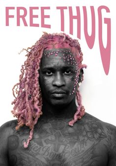 a man with pink dreadlocks on his face and chest is standing in front of a sign that says free thug