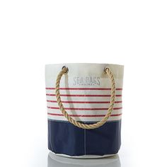 a blue and white striped bag with rope handles on the handle, sitting against a white background