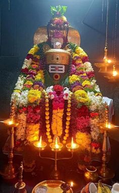 the idol is adorned with flowers and candles for diwaling or offering to people