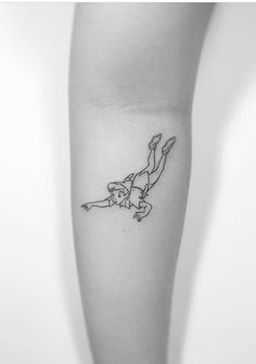 a woman's leg with a small tattoo of a skateboarder on it