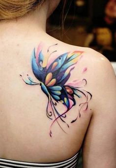 a woman with a colorful butterfly tattoo on her back