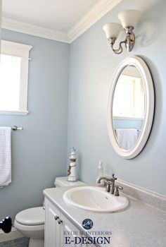 a bathroom with blue walls and white fixtures