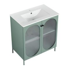 a white sink sitting next to a green cabinet