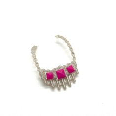 a pink and silver bracelet on a white background