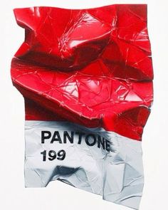 a piece of red plastic sitting on top of a white sheet with the word pantone printed on it