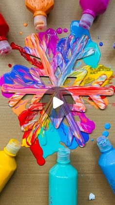 several different colors of paint are arranged in the shape of a flower on a table