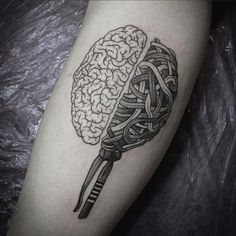 a black and white tattoo with a brain on it