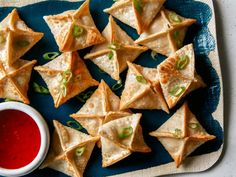 small crackers with dipping sauce on a blue plate