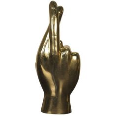 a gold colored statue of a hand making the peace sign