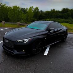 a black sports car parked in a parking lot