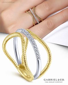 Two ribbons of twisted 14K yellow gold are pulled inexorably toward a central thread of 14K white gold and brilliant 0.15ct pavé diamonds. This two-tone ring with a gracefully curved silhouette takes style to the next level. LR51525M45JJ #GabrielNY #DiamondJewelry #FineJewelry #GabrielAndCo #UniqueJewelry #FineJewelry#FashionJewelry#UniqueJewelry#GiftIdeas#UniqueGifts #DiamondJewelry #Jewelry #LadiesRing#FashionLadiesRing#YellowWhiteGoldRing#YellowWhiteGoldFashionRing#GoldRing#GoldFashionRing Ladies Rings, Criss Cross Ring, Wedding Ring Necklaces, Fancy Rings, Gold Rings Fashion, Ladies Ring, Cross Ring, Diamond Hoop Earrings, Fine Jewelry Collection