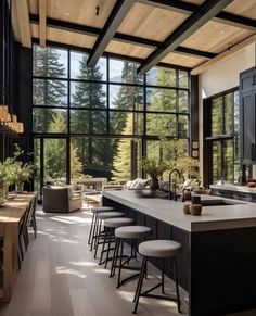 an open kitchen with lots of counter space and stools in front of the bar