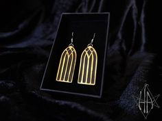 These one-of-a-kind Gothic Window Earrings make a statement with their raw and edgy brass design. The finely detailed Gothic window adds a touch of class to any look, captivating onlookers with an elegant yet mysterious aesthetic. An ideal addition to an artful ensemble. These earrings come on silver ear wires but if you require another type of closure, please message and ask! Handmade Gothic Gold Earrings, Gothic Plug Earrings For Gifts, Gold Gothic Earrings As Gift, Architecture Gothic, Gothic Window, Gothic Arch, Window Architecture, Gothic Windows, Gothic Jewellery