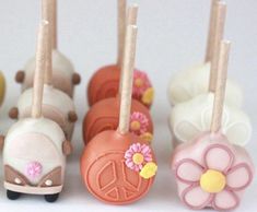 small cake pops decorated with flowers and peace signs