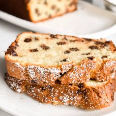 two slices of chocolate chip bread on white plates