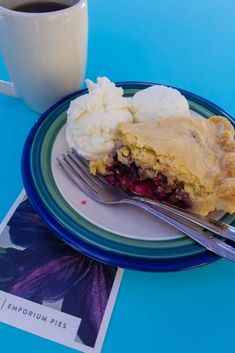 a piece of pie on a plate next to a cup of coffee